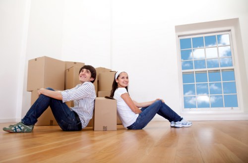 Local movers carrying items from a flat with stairs in New Cross