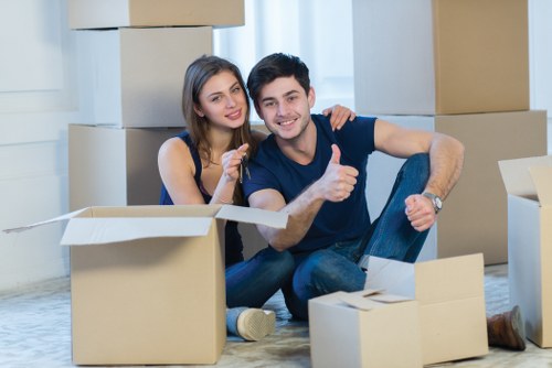 Removalists carefully loading household items for transport in New Cross