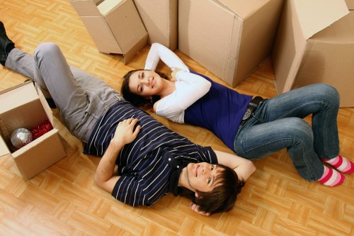 Packed moving boxes and furniture ready for transport in New Cross